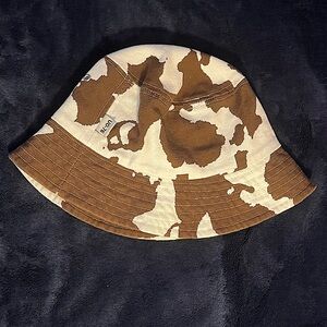 Brown and cream cow print bucket hat.